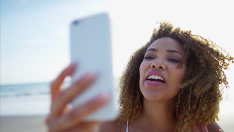 Relaxed-African-American-female-in-sundress-on-beach