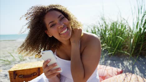 Portrait-of-African-American-female-having-beach-picnic