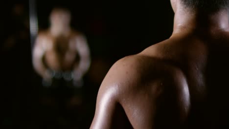 Athlete-Dumbbell-Side-Raises-in-Dark-Gym