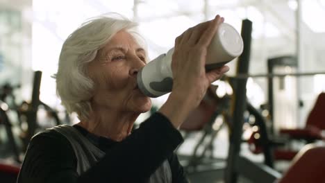 Elderly-Woman-Drinking-Water-after-Workout