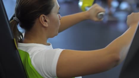 Woman-Training-on-Chest-Press-Machine-in-Gym