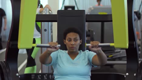 Black-Woman-Training-with-Chest-Press-Machine