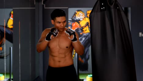 Asian-men's-exercise-with-boxing-in-a-gym.-Living--healthy-lifestyle-concept.