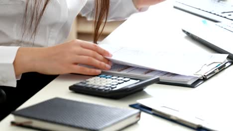 woman-hands-filling-documents-in-modern-office