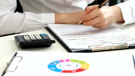 woman-hands-filling-documents-in-modern-office