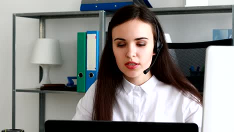 woman-speaking-on-headset-in-modern-office