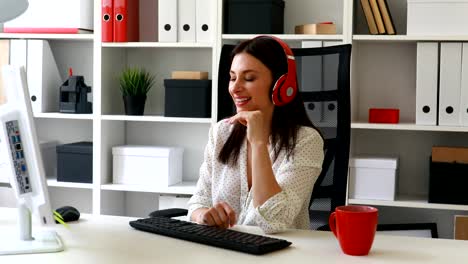 businesswoman-listening-music,-looking-to-monitor-and-smiling