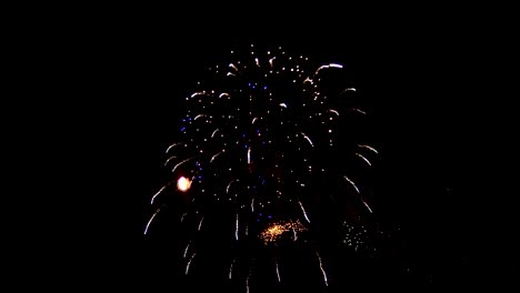 Festive-fireworks-at-night.-Beautiful-lights-connect-with-each-other.-Some-of-the-lights-are-visible-close,-others-shine-all-over-the-sky.-Many-colors-and-beautiful-figures-from-the-light