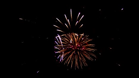 Festive-fireworks-at-night.-In-the-dark-sky-there-are-beautiful-colored-sparks,-red-and-blue-colors-are-located-throughout-the-sky.-Wonderful-color-lines-of-festive-fireworks