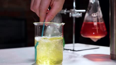 Close-up-of-scientist-mixing-chemical-solution-for-experiment-at-laboratory