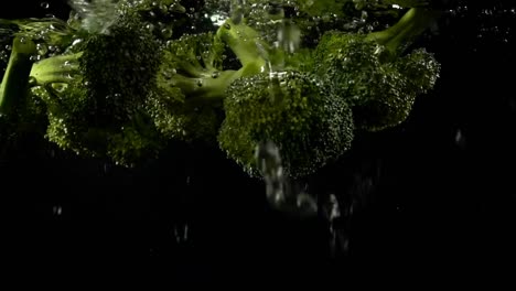 Falling-of-cabbage-of-broccoli-in-water.-Slow-motion.