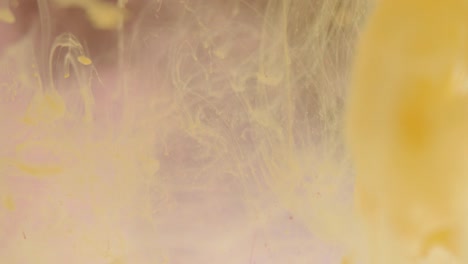 Yellow-Paint-Dissolving-on-Mauve-Background