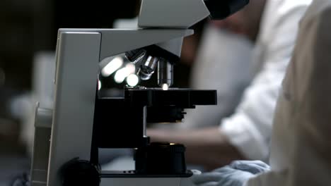 University-Students-in-a-chemistry-lab-look-through-a-microscope-for-experiments