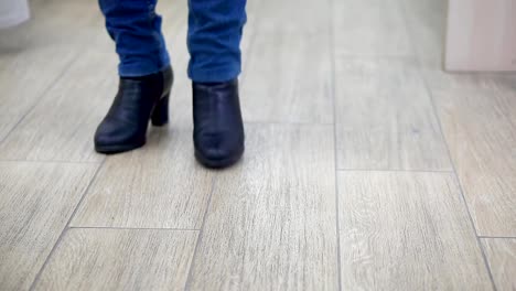 Frau-in-einem-Bekleidungsgeschäft,-in-eine-Umkleidekabine,-close-up-Beine-in-jeans