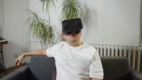 men-in-white-shirt-enjoying-vr-at-home-virtual-reality-goggles