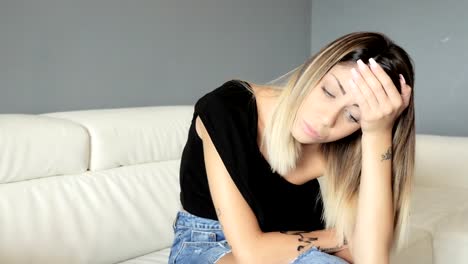 Sexy,worried-and-lonely-woman-sitting-on-the-couch