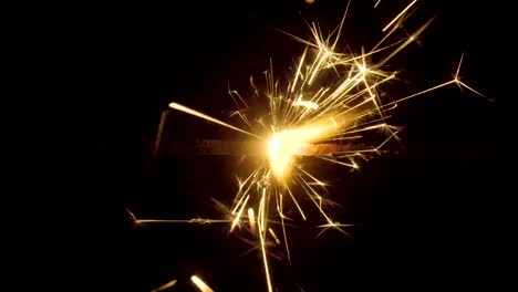 Firework-sparkler-burning-on-black-background