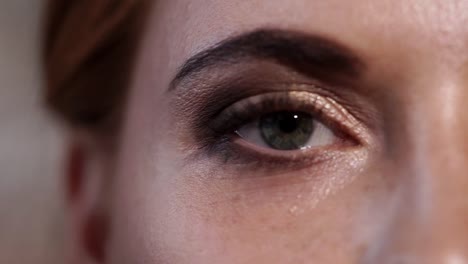 close-up-shot-of-the-gray-blue-eye-of-adult-woman-who-blinks-and-closes-her-eye