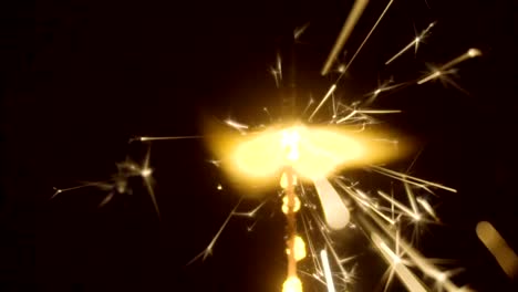 Firework-sparkler-burning-on-black-background-in-slow-motion