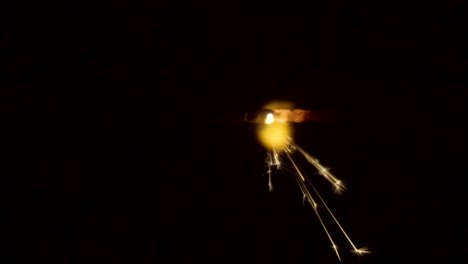 Firework-sparkler-burning-on-black-background-in-slow-motion