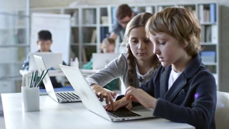 Girl-Helping-Boy-in-Class