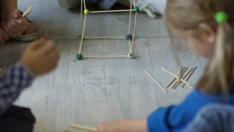 Profesor-y-los-niños-haciendo-el-cubo-de-madera