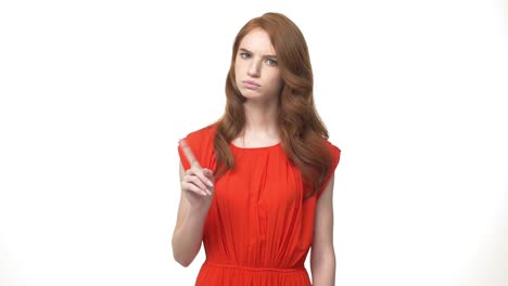 Young-beautiful-caucasian-woman-in-gorgeous-orange-dress-standing-and-say-no-isolated-over-white-background-while-looking-camera.