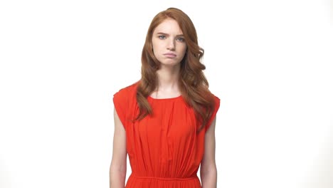 Young-beautiful-caucasian-woman-in-gorgeous-orange-dress-standing-and-say-no-isolated-over-white-background-while-looking-camera.