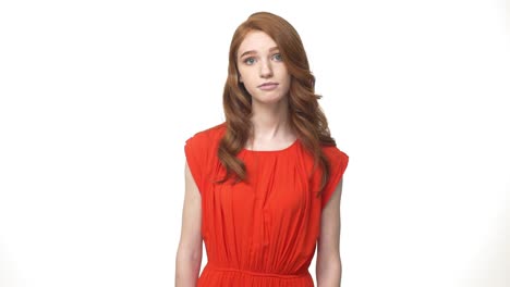 Young-beautiful-caucasian-woman-in-gorgeous-orange-dress-standing-and-say-no-isolated-over-white-background-while-looking-camera.