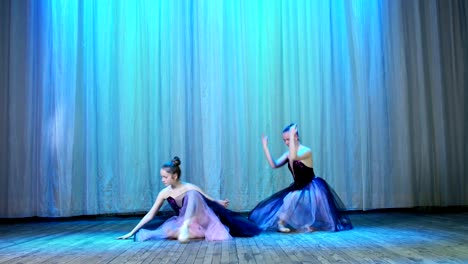 ballet-rehearsal,-on-the-stage-of-the-old-theater-hall.-Young-ballerinas-in-black-elegant-dresses-and-pointe-shoes,-dance-elegantly-certain-ballet-motion,-pirouett-from-4-position