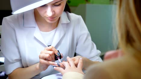 Professional-manicure-procedure-in-beauty-salon