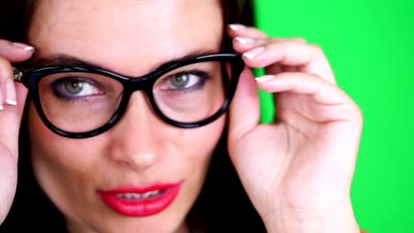 green-background,-chromeakey.-portrait-of-a-sexy-brunette-woman-with-red-lips,-in-stylish-glasses,-spectacles,-eroticly,-playfully-moves,-looking-sexually-at-camera,-posing-in-studio