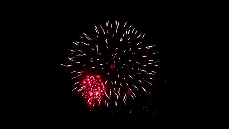 Celebratory-performances.-Fireworks-against-the-background-of-the-night-sky.-Red-and-violet-flashes,-a-beautiful-flame.-An-exciting-event-of-two-exploding-lights-of-fireworks