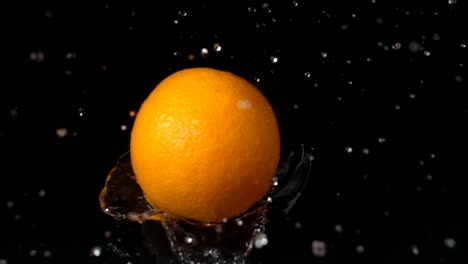 Falling-of-orange-in-water.-Slow-motion.