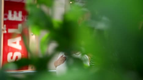 Slow-motion-tracking-shot-of-two-young-women-walking-along-shopping-mall-in-sales-period-and-talking