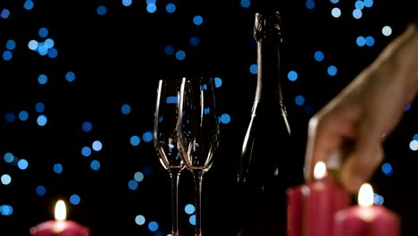 Lighting-up-romantic-candles-next-to-a-bottle