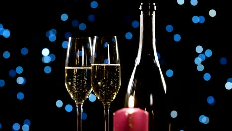 Two-glasses-of-champagne,-romantic-candle