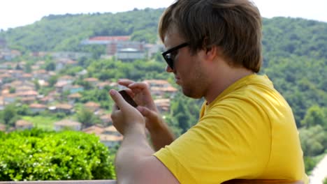 Young-male-tourist-resting-on-bench