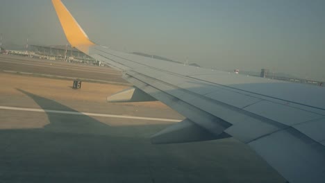 Airplane-flight.-Wing-of-an-airplane-flying-above-the-clouds-with-sunset-sky.-View-from-the-window-of-the-plane.-Aircraft.-Traveling-by-air.-4K-UHD-video