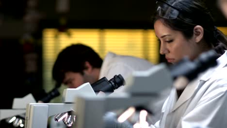 Studenten-in-einem-Labor-Blick-durch-ein-Mikroskop-während-ihr-experiment