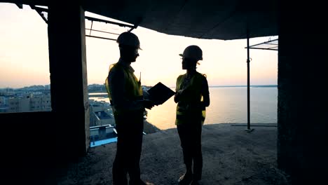 Silhouette-of-builders-working-at-a-construction-site.