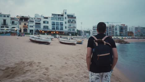 Man-walking-on-beach-alone-in-summer.