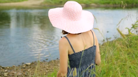 Woman-resting-on-a-river-bank