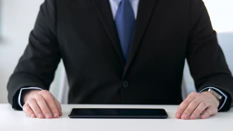 close-up-of-businessman-with-tablet-pc-at-office