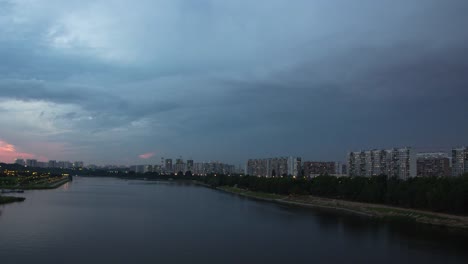 Paisaje-urbano-con-tráfico-fluvial-y-el-movimiento-de-las-nubes-al-atardecer