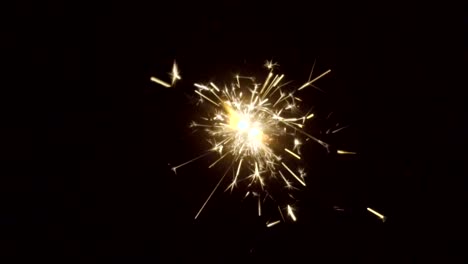 Firework-sparkler-burning-on-black-background-in-slow-motion