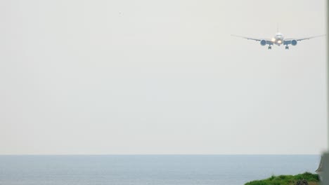 Airplane-approaching-over-ocean