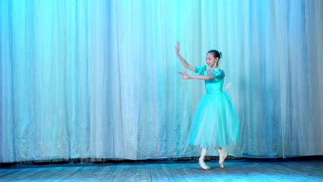 ballet-rehearsal,-on-the-stage-of-the-old-theater-hall.-Young-ballerina-in-blue-ballet-dress-and-pointe-shoes,-dances-elegantly-certain-ballet-motion,-arabesque