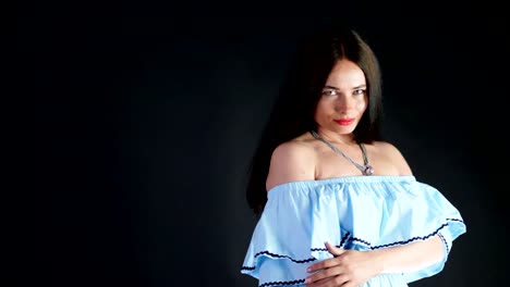 portrait-of-a-sexy-brunette-woman-with-red-lips-who-eroticly-and-playfully-moves-and-looking-sexually-at-camera,-posing-in-studio.-dark-gray-background