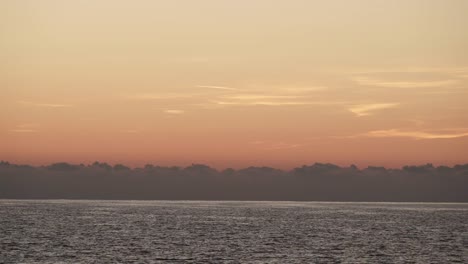 Rot-orange-Himmel-nach-Sonnenuntergang-über-der-Meeresoberfläche